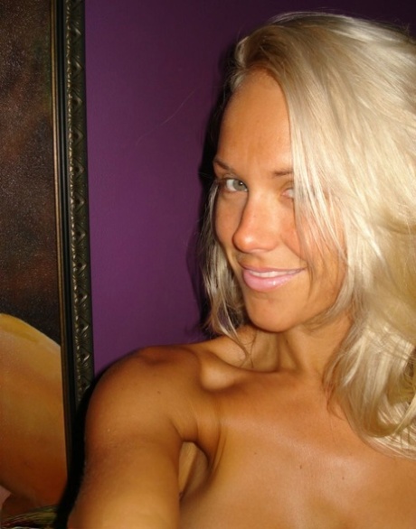Hot blonde Aussie Jewel displays her big boobs while taking nude selfies