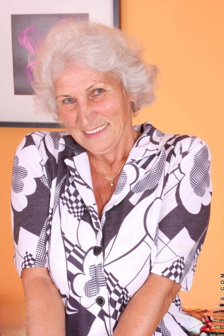 Grey haired granny Betty exposes her saggy juggs and fingers her clam