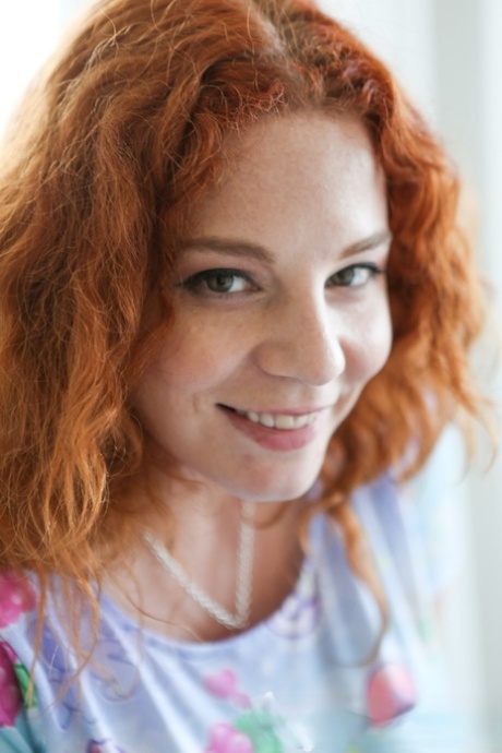 Redhead hottie Avalon shows her awesome curves & fondles her great big tits