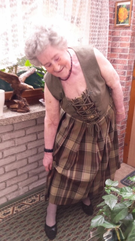 Short-haired granny Pitschka undressing and showing her saggy boobs